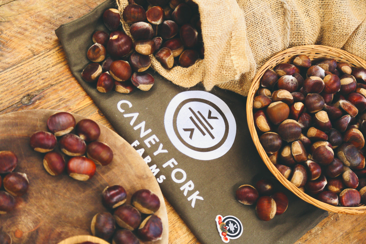 Chestnuts with a Caney Fork Farms branded mat on a wooden surface